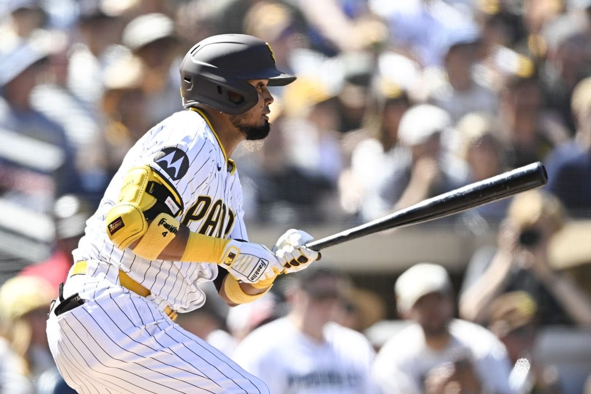 Sep 24, 2025; San Diego, California, USA; San Diego Padres first baseman Luis Arraez (4) hits a single during the first inning against the Milwaukee Brewers at Petco Park. Mandatory Credit: Denis Poroy-Imagn Images