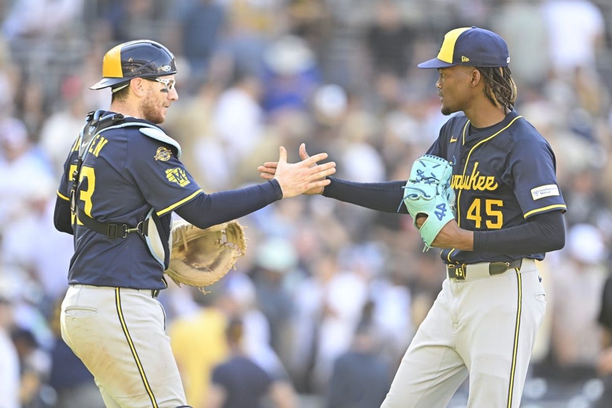 Sep 24, 2025; San Diego, California, USA; Milwaukee Brewers relief pitcher Abner Uribe (45) and Danny Jansen (33) celebrate after the Brewers beat the San Diego Padres at Petco Park. Mandatory Credit: Denis Poroy-Imagn Images