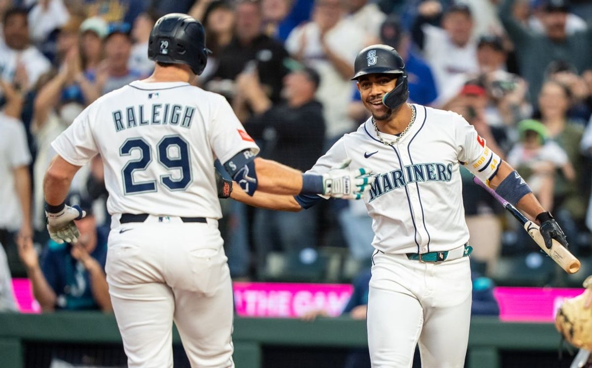 Sep 24, 2025; Seattle, Washington, USA; Seattle Mariners catcher Cal Raleigh (29) is congratulated by centerfielder Julio Rodriguez (44) after hitting a solo home run during the first inning against the Colorado Rockies at T-Mobile Park. Mandatory Credit: Stephen Brashear-Imagn Images