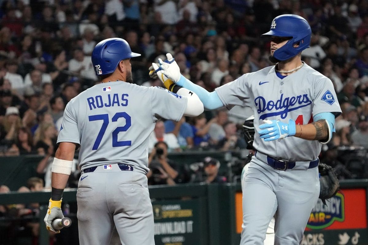 Sep 24, 2025; Phoenix, Arizona, USA; Los Angeles Dodgers outfielder Andy Pages (44) celebrates with Miguel Rojas after hitting a two-run home run against the Arizona Diamondbacks in the fourth inning at Chase Field. Mandatory Credit: Rick Scuteri-Imagn Images