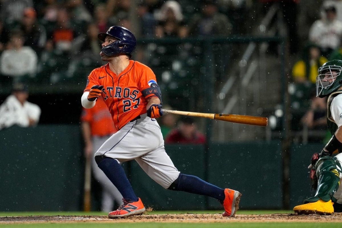 Sep 24, 2025; West Sacramento, California, USA; Houston Astros second baseman Jose Altuve (27) hits a fly ball against the Athletics in the sixth inning at Sutter Health Park. Mandatory Credit: Cary Edmondson-Imagn Images