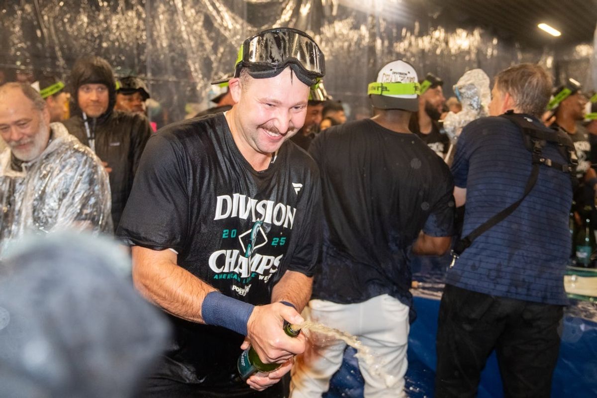 Sep 24, 2025; Seattle, Washington, USA; Seattle Mariners catcher Cal Raleigh (29), left, celebrates in the clubhouse after winning the American League West Division during a game against the Colorado Rockies at T-Mobile Park. Mandatory Credit: Stephen Brashear-Imagn Images