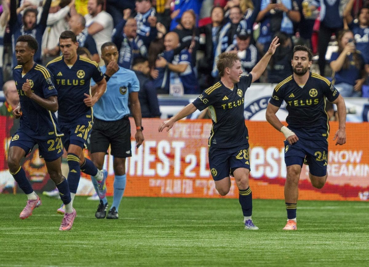 Sep 24, 2025; Vancouver, British Columbia, CAN; Vancouver Whitecaps FC back Tate Johnson (28) (L) celebrates with teammate Brian White (24) after White’s tying goal against Portland Timbers in the second half at BC Place. Mandatory Credit: Christopher Morris-Imagn Images
