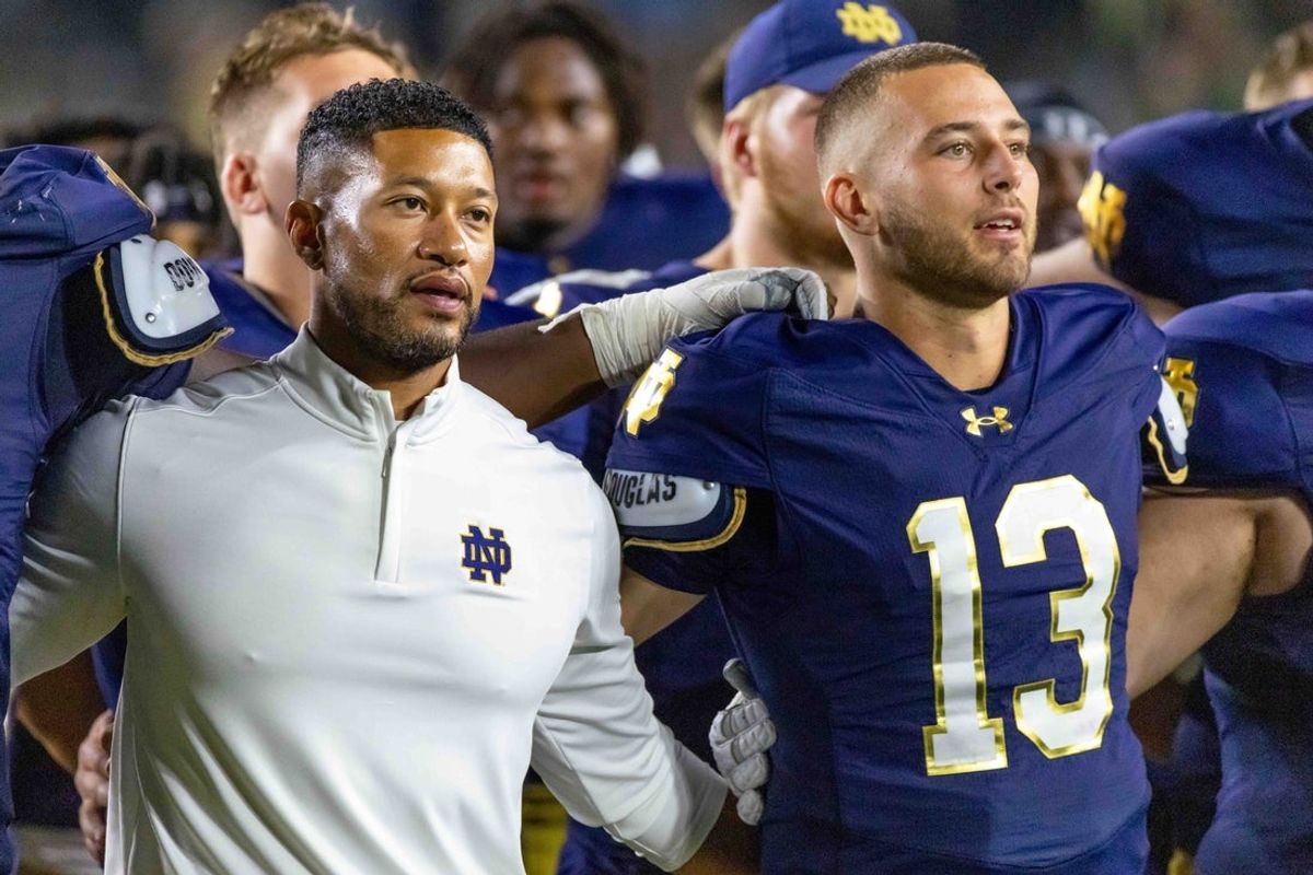 Sep 20, 2025; South Bend, Indiana, USA; Notre Dame Fighting Irish head coach Marcus Freeman and quarterback CJ Carr (13) sing the alma mater after beating the Purdue Boilermakers at Notre Dame Stadium. Mandatory Credit: Michael Caterina-Imagn Images