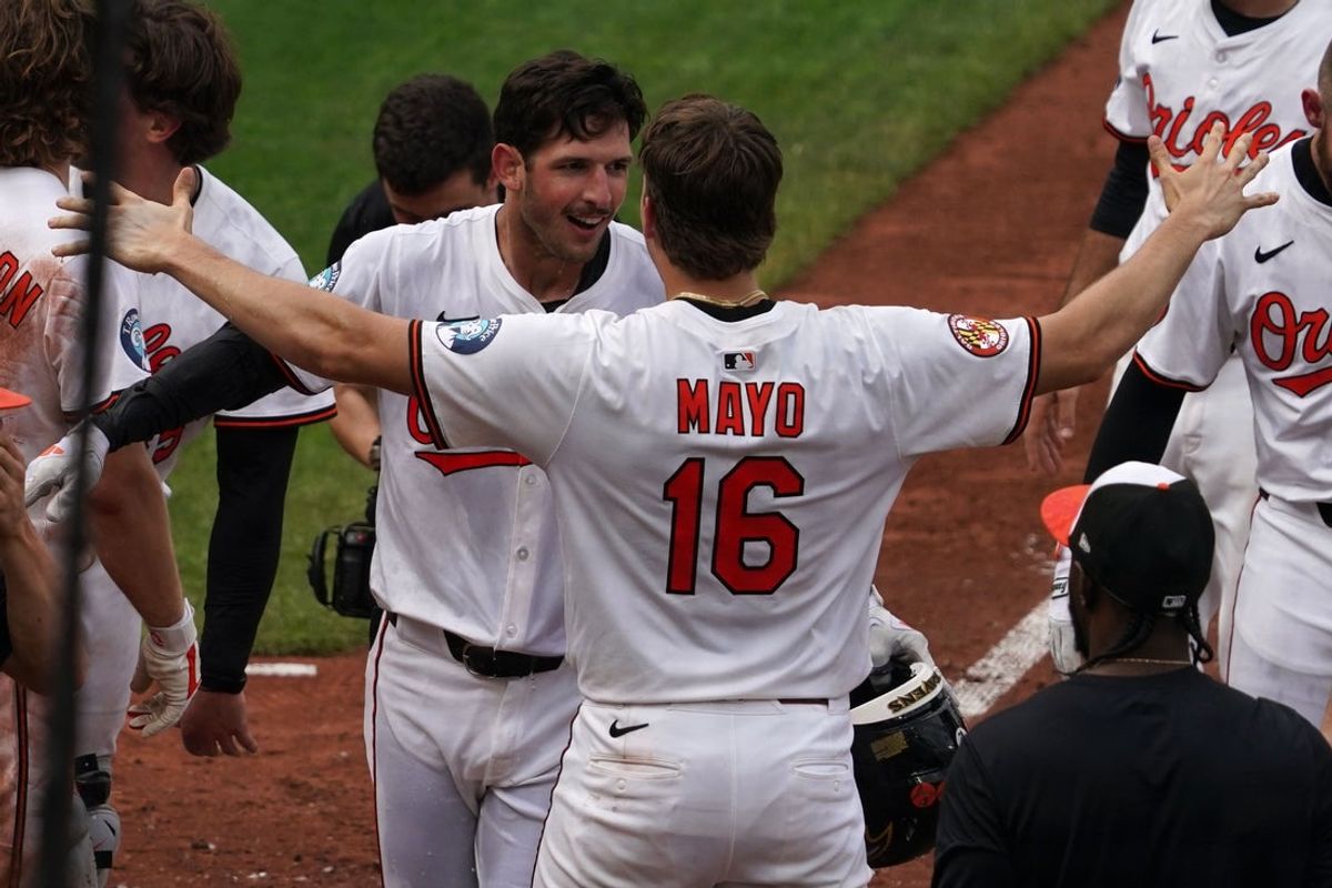 Sep 25, 2025; Baltimore, Maryland, USA; Baltimore Orioles outfielder Dylan Beavers (12) is greeted by first baseman Coby Mayo (16) after connecting on a game winning solo home run in the ninth inning against the Tampa Bay Rays at Oriole Park at Camden Yards. Mandatory Credit: Mitch Stringer-Imagn Images