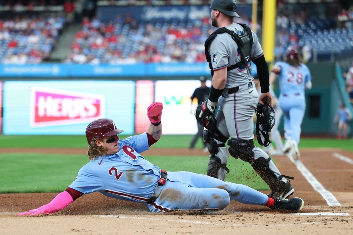 Sep 25, 2025; Philadelphia, Pennsylvania, USA; Philadelphia Phillies outfielder Harrison Bader (2) slides home for a run against the Miami Marlins during the first inning at Citizens Bank Park. Mandatory Credit: Bill Streicher-Imagn Images