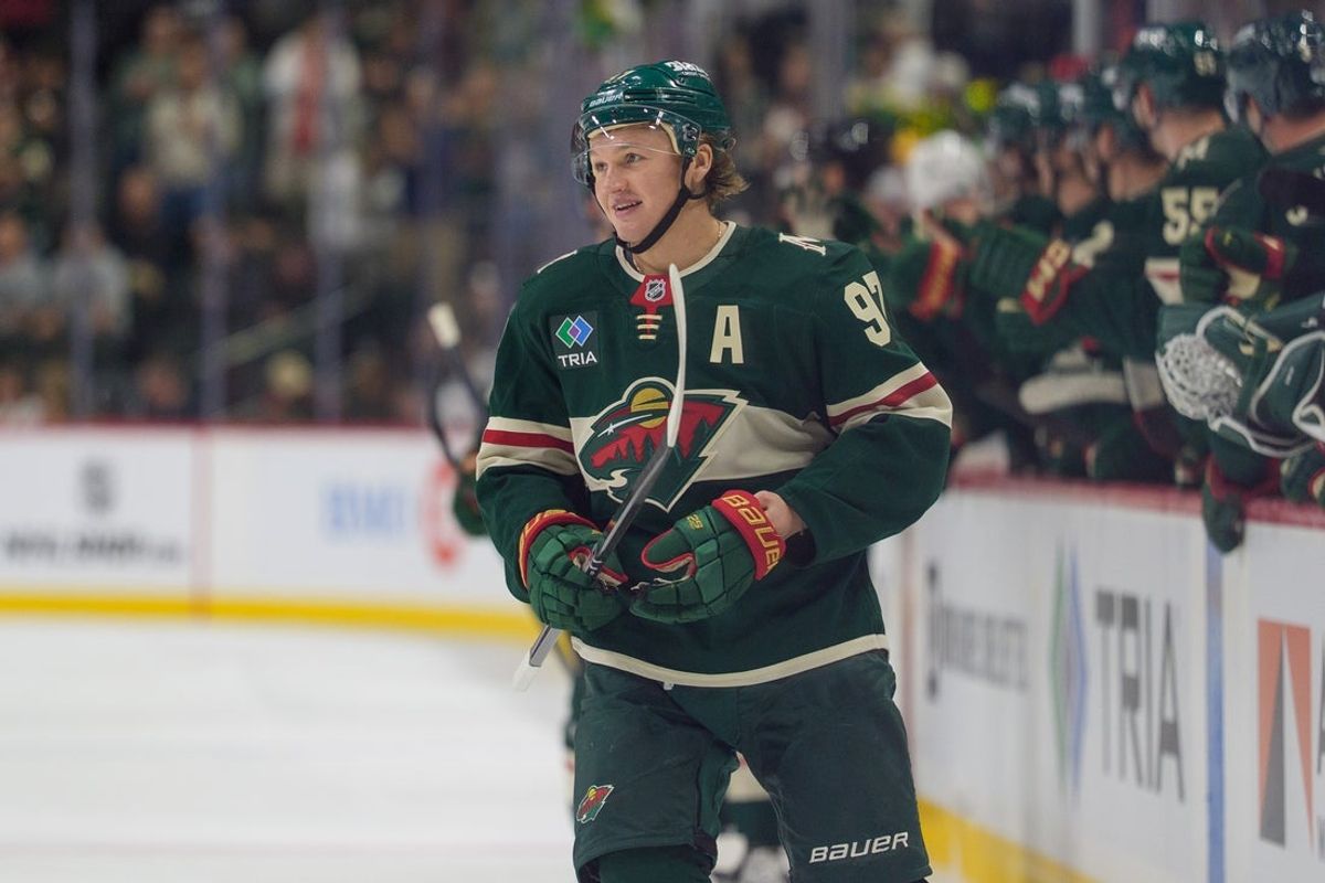 Sep 25, 2025; Saint Paul, Minnesota, USA; Minnesota Wild left wing Kirill Kaprizov (97) smiles as center Marco Rossi (23) scores the first goal of the game against the Dallas Stars in the first period at Grand Casino Arena. Mandatory Credit: Matt Blewett-Imagn Images