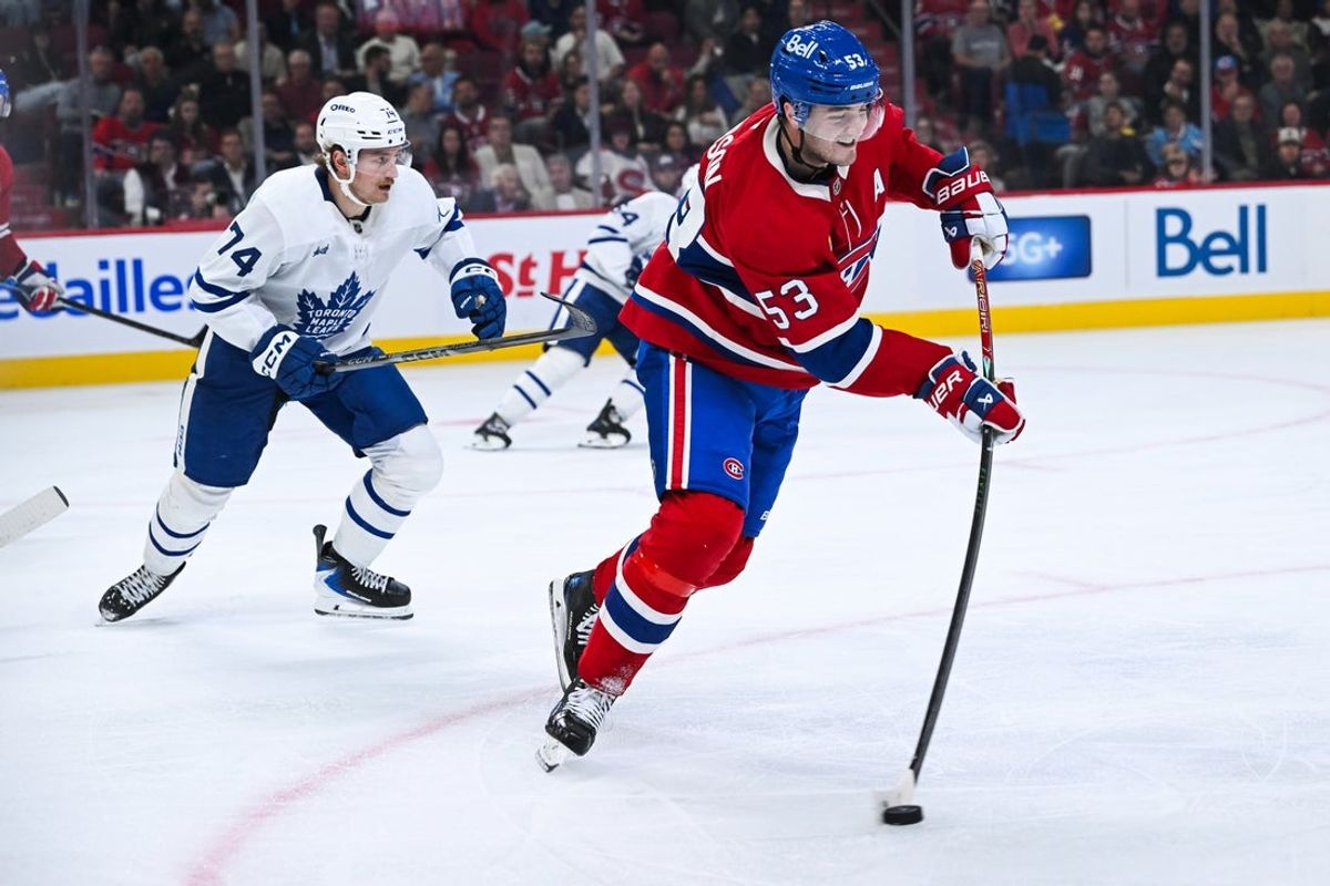 Sep 25, 2025; Montreal, Quebec, CAN; Montreal Canadiens defenseman Noah Dobson (53) shoots the puck away against the Toronto Maple Leafs during the second period at Bell Centre. Mandatory Credit: David Kirouac-Imagn Images