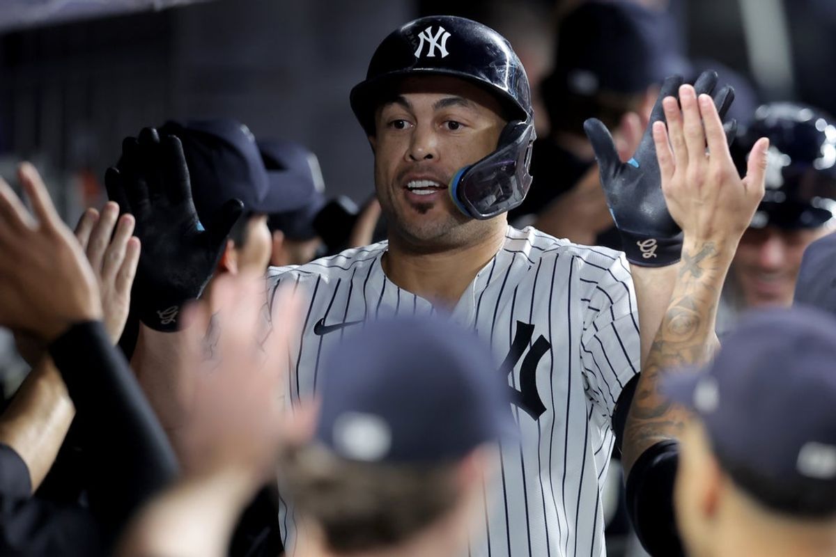 Sep 26, 2025; Bronx, New York, USA; New York Yankees designated hitter Giancarlo Stanton (27) celebrates his two run home run against the Baltimore Orioles with teammates in the dugout during the first inning at Yankee Stadium. Mandatory Credit: Brad Penner-Imagn Images
