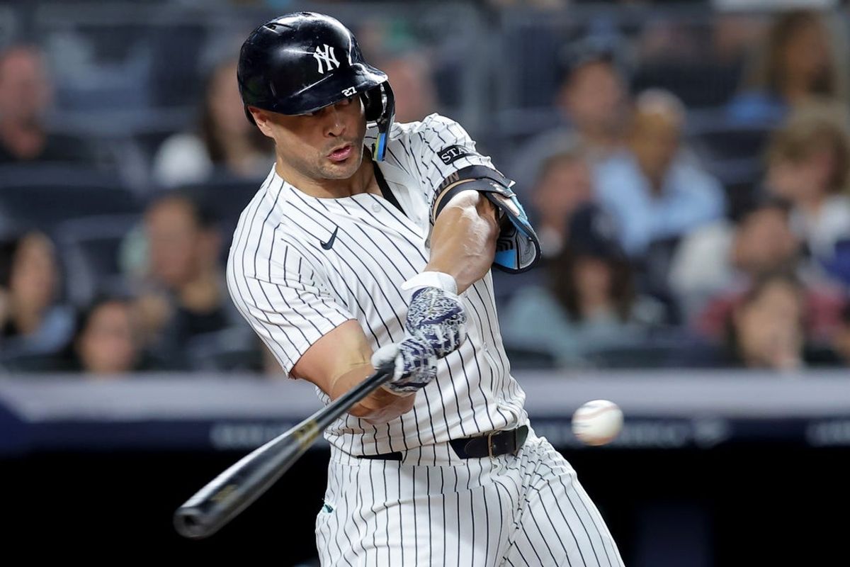 Sep 26, 2025; Bronx, New York, USA; New York Yankees designated hitter Giancarlo Stanton (27) hits a two run home run against the Baltimore Orioles during the third inning at Yankee Stadium. Mandatory Credit: Brad Penner-Imagn Images