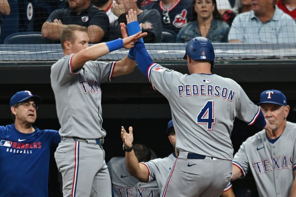Sep 26, 2025; Cleveland, Ohio, USA; Texas Rangers designated hitter Joc Pederson (4) celebrates after scoring against the Cleveland Guardians during the first inning at Progressive Field. Mandatory Credit: Ken Blaze-Imagn Images