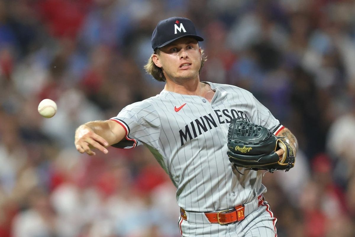 Sep 26, 2025; Philadelphia, Pennsylvania, USA; Minnesota Twins pitcher Travis Adams (45) throws to first for an out against the Philadelphia Phillies during the sixth inning at Citizens Bank Park. Mandatory Credit: Bill Streicher-Imagn Images