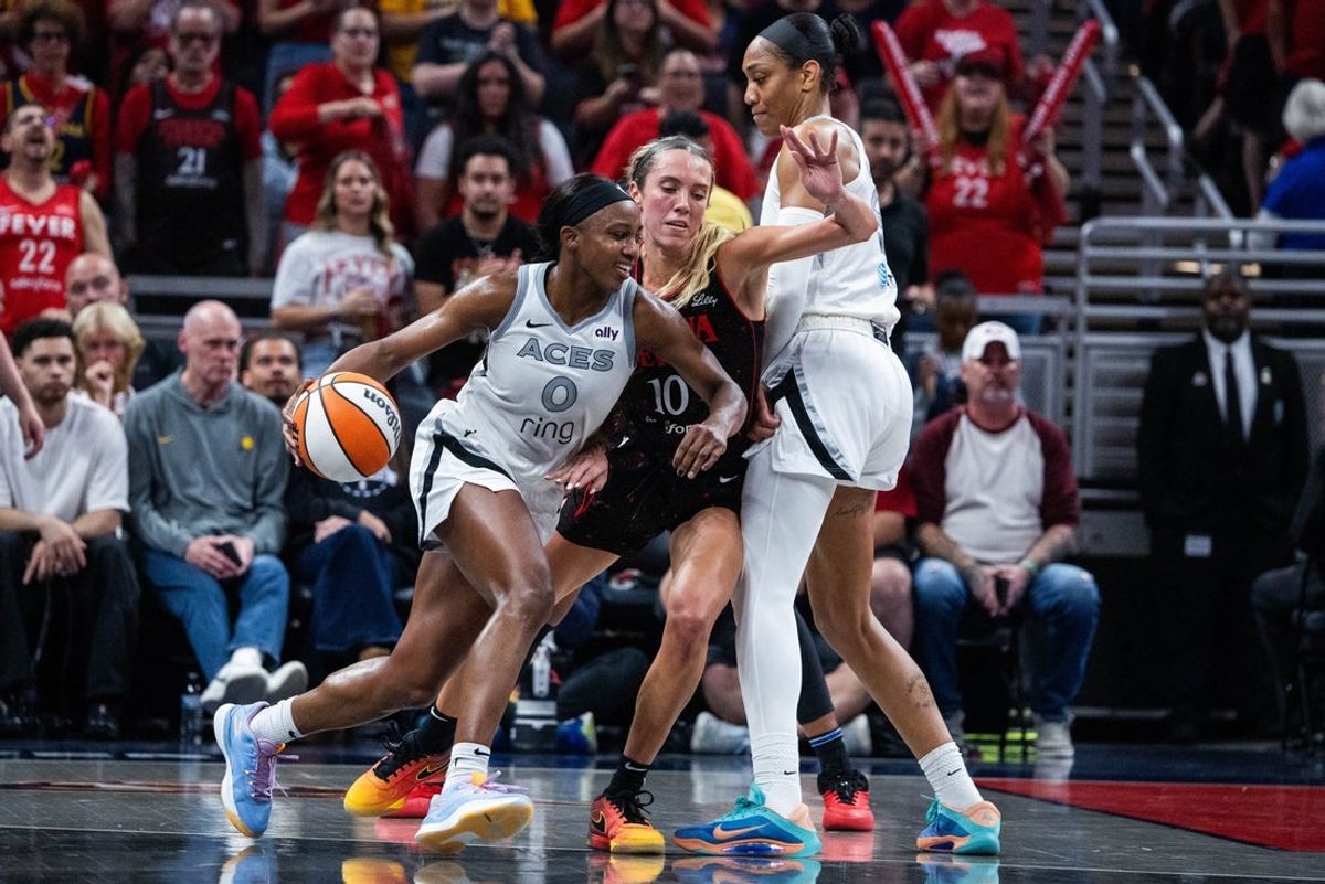 Sep 26, 2025; Indianapolis, Indiana, USA; Las Vegas Aces guard Jackie Young (0) dribbles the ball while Indiana Fever guard Lexie Hull (10) defends during game three of the second round for the 2025 WNBA Playoffs at Gainbridge Fieldhouse. Mandatory Credit: Trevor Ruszkowski-Imagn Images