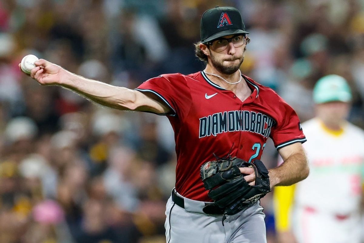 Sep 26, 2025; San Diego, California, USA; Arizona Diamondbacks starting pitcher Zac Gallen (23) throws to first base for an out during the second inning against the San Diego Padres at Petco Park. Mandatory Credit: David Frerker-Imagn Images