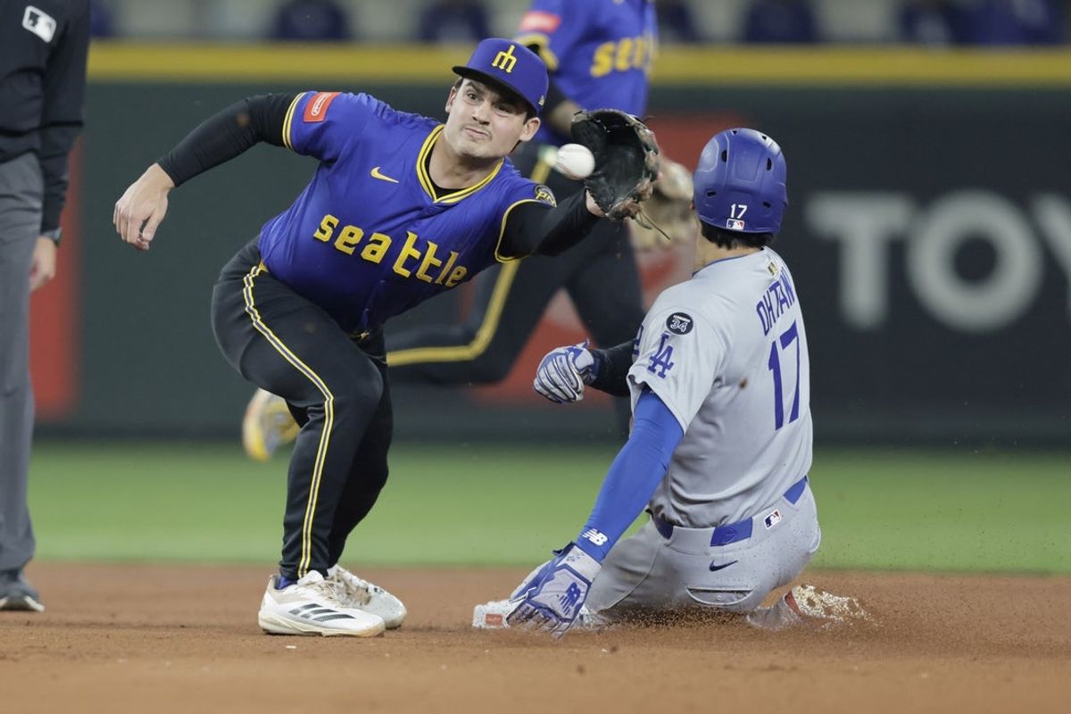 Sep 26, 2025; Seattle, Washington, USA; Los Angeles Dodgers designated hitter Shohei Ohtani (17) steals second as Seattle Mariners second baseman Cole Young (2) reaches for the throw during the third inning at T-Mobile Park. Mandatory Credit: John Froschauer-Imagn Images