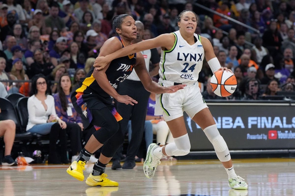Sep 26, 2025; Phoenix, Arizona, USA; Minnesota Lynx forward Napheesa Collier (24) shields the ball from Phoenix Mercury forward Alyssa Thomas (25) during game three of the second round for the 2025 WNBA Playoffs at PHX Arena. Mandatory Credit: Rick Scuteri-Imagn Images