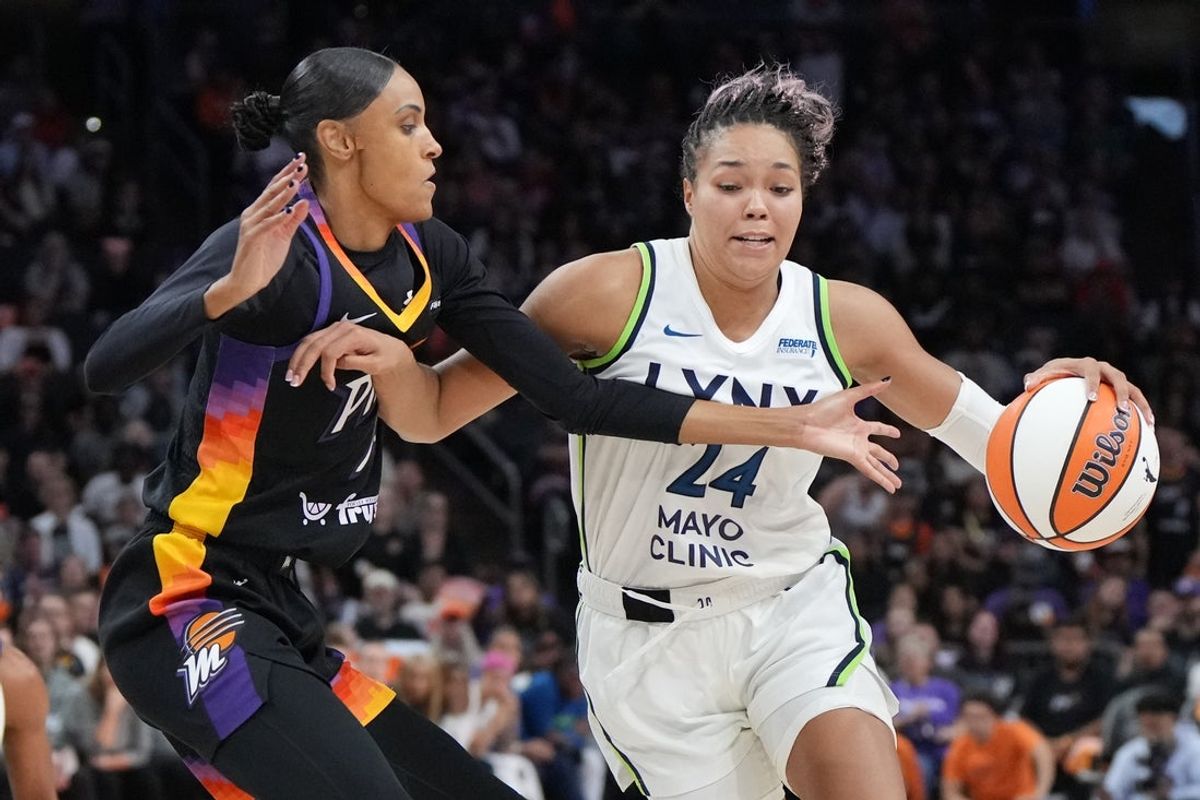 Sep 26, 2025; Phoenix, Arizona, USA; Minnesota Lynx forward Napheesa Collier (24) drives the ball against Phoenix Mercury forward DeWanna Bonner (14) during game three of the second round for the 2025 WNBA Playoffs at PHX Arena. Mandatory Credit: Rick Scuteri-Imagn Images