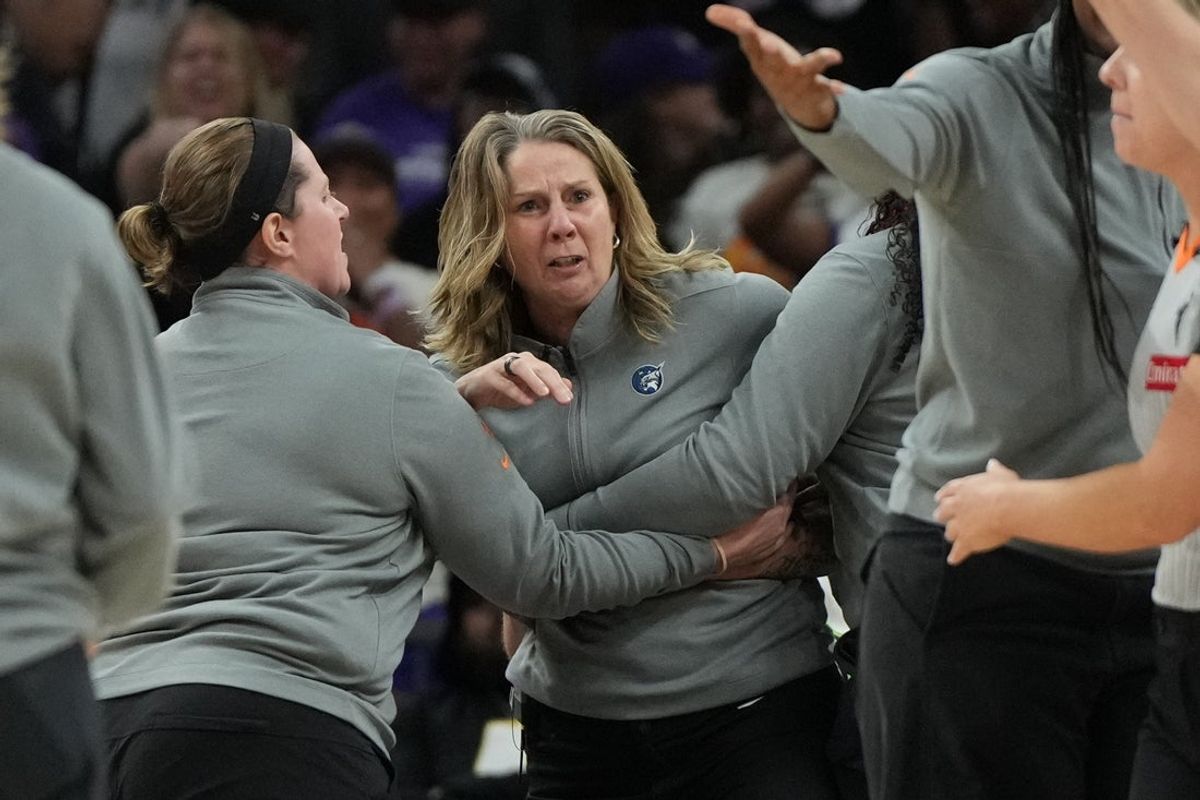 Sep 26, 2025; Phoenix, Arizona, USA; Minnesota Lynx head coach Cheryl Reeve is held back after being ejected during game three against the Phoenix Mercury of the second round for the 2025 WNBA Playoffs at PHX Arena. Mandatory Credit: Rick Scuteri-Imagn Images