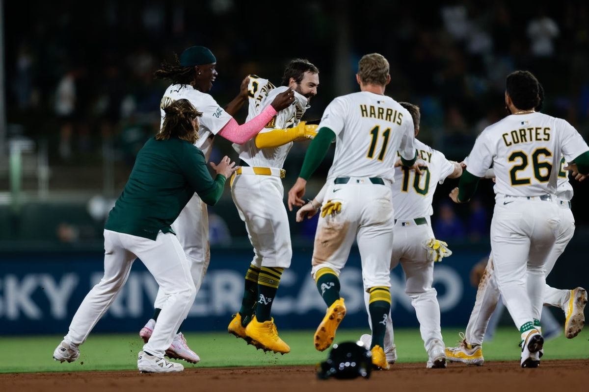 Sep 26, 2025; West Sacramento, California, USA; Athletics catcher Shea Langeliers (23) celebrates with teammates after hitting a walk-off RBI double during the ninth inning against the Kansas City Royals at Sutter Health Park. Mandatory Credit: Sergio Estrada-Imagn Images