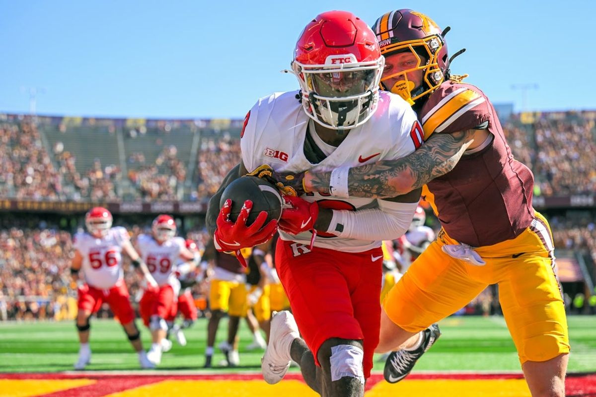 Sep 27, 2025; Minneapolis, Minnesota, USA;  Rutgers Scarlet Knights wide receiver DT Sheffield (0) catches a four-yard pass for a touchdown as Minnesota Golden Gophers defensive back Aidan Gousby (7) defends during the first quarter at Huntington Bank Stadium. Mandatory Credit: Nick Wosika-Imagn Images