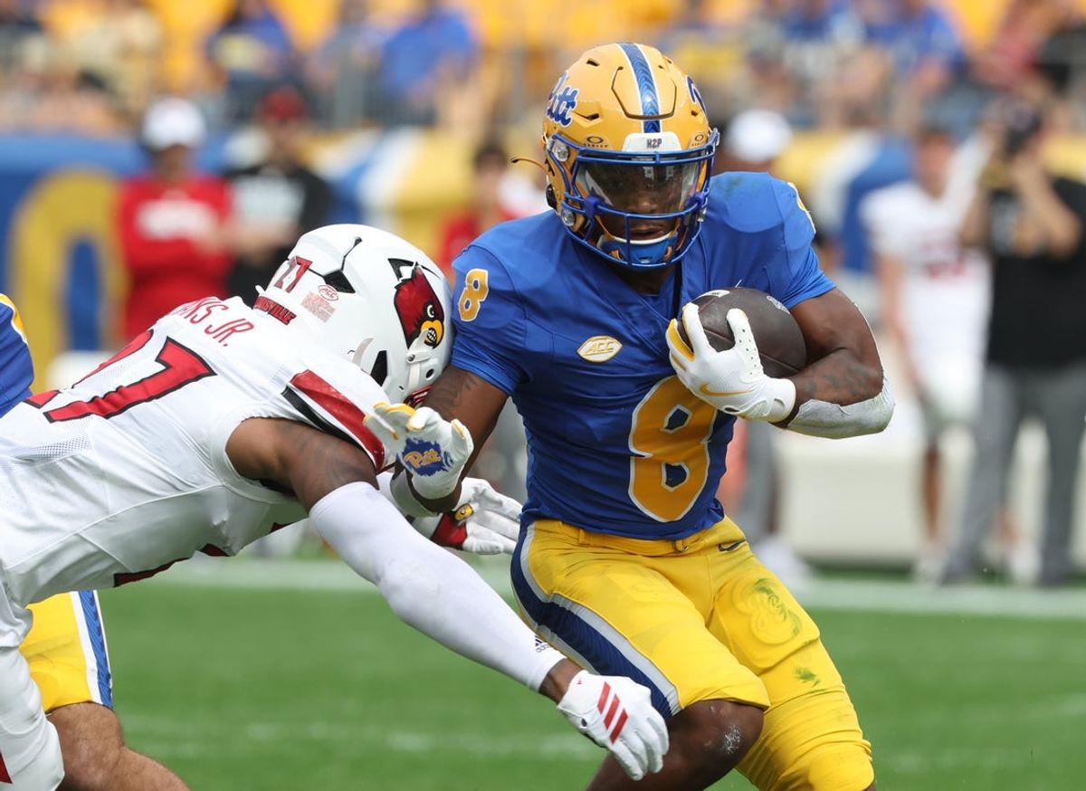 Sep 27, 2025; Pittsburgh, Pennsylvania, USA;  Pittsburgh Panthers running back Juelz Goff (8) runs the ball against Louisville Cardinals defensive back JoJo Evans Jr. (27) during the first quarter at Acrisure Stadium. Mandatory Credit: Charles LeClaire-Imagn Images