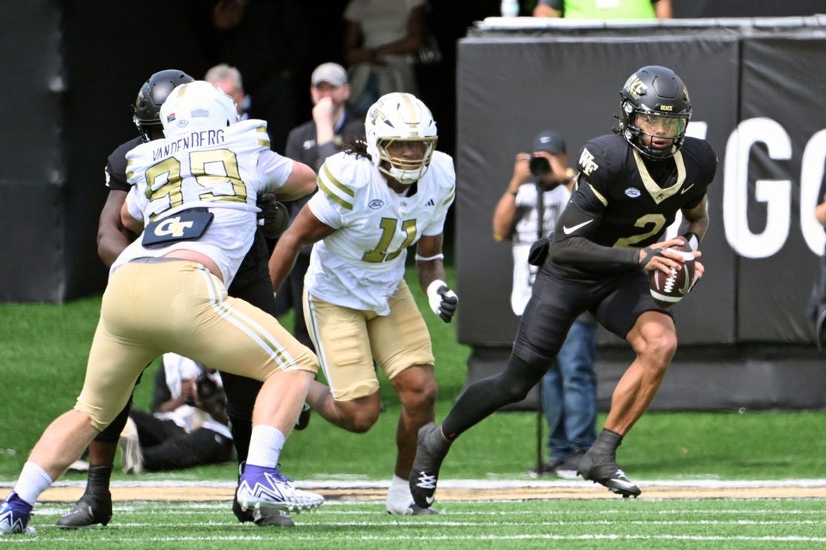 Sep 27, 2025; Winston-Salem, North Carolina, USA;  Wake Forest Demon Deacons quarterback Robby Ashford (2) runs the ball against Georgia Tech Yellow Jackets defensive lineman Brayden Manley (11) during the first quarter at Allegacy Federal Credit Union Stadium. Mandatory Credit: Zachary Taft-Imagn Images