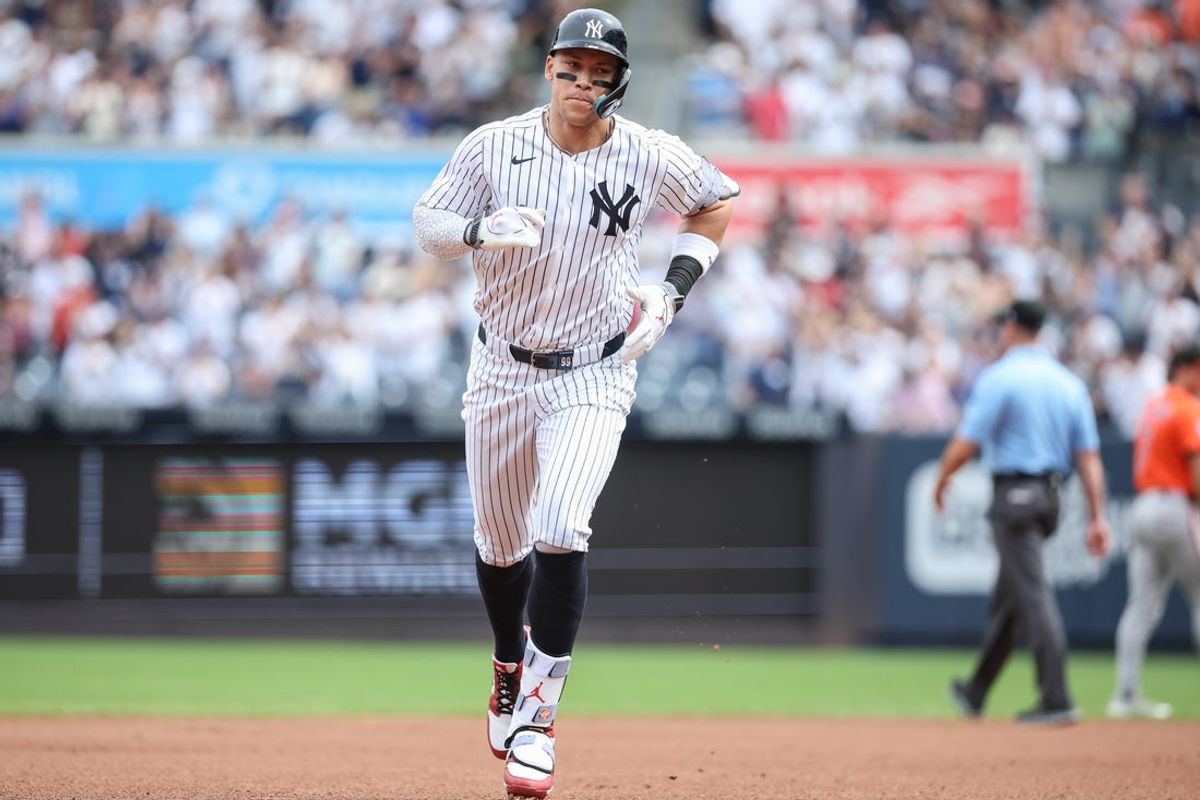 Sep 27, 2025; Bronx, New York, USA;  New York Yankees right fielder Aaron Judge (99) hits a solo home run in the first inning against the Baltimore Orioles at Yankee Stadium. Mandatory Credit: Wendell Cruz-Imagn Images