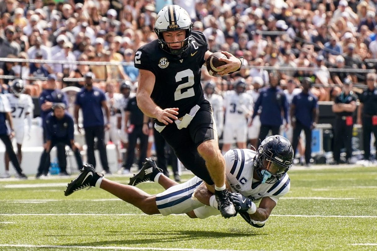 Vanderbilt quarterback Diego Pavia (2) runs in a touchdown past Utah State cornerback Noah Avinger (1) during the second quarter at FirstBank Stadium in Nashville, Tenn., Saturday, Sept. 27, 2025.