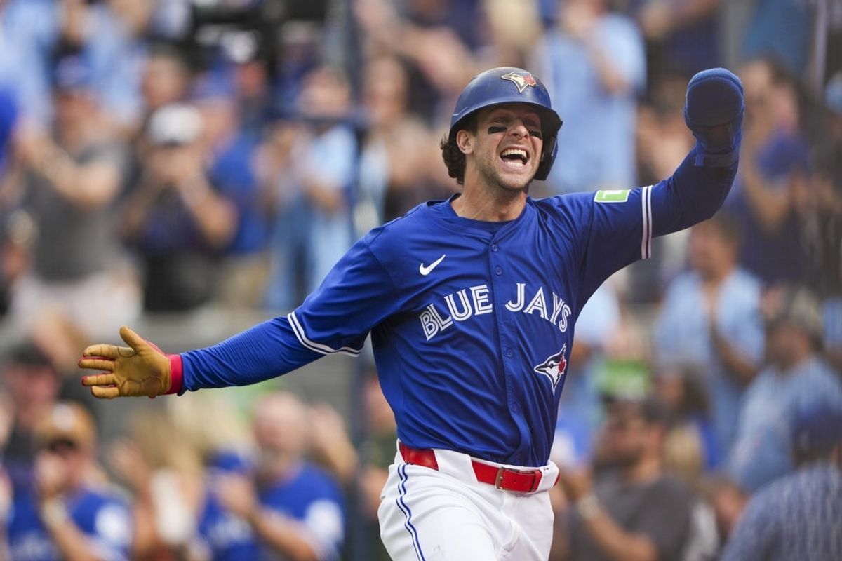 Sep 27, 2025; Toronto, Ontario, CAN; Toronto Blue Jays third base Ernie Clement (22) celebrates after scoring against the Tampa Bay Rays during the second inning at Rogers Centre. Mandatory Credit: Kevin Sousa-Imagn Images