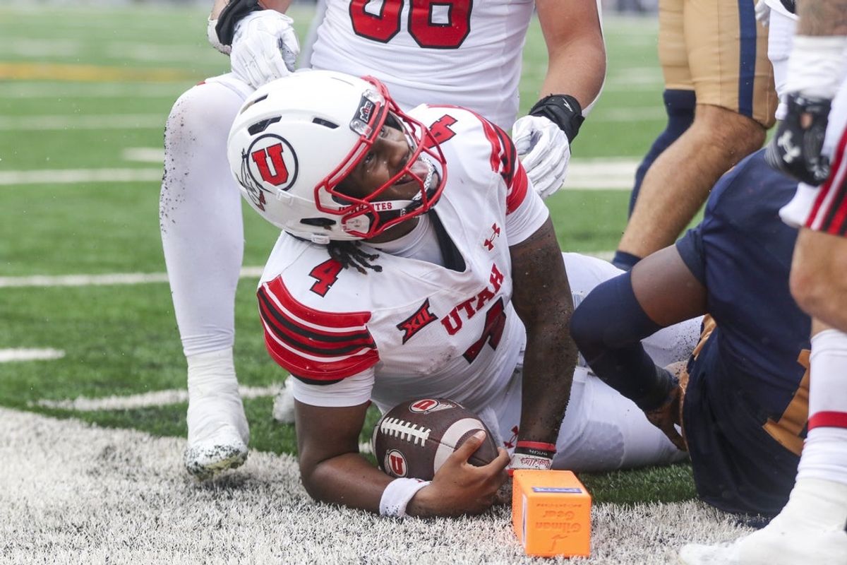 Sep 27, 2025; Morgantown, West Virginia, USA; Utah Utes quarterback Devon Dampier (4) reacts after running the ball for a touchdown during the first quarter against the West Virginia Mountaineers at Milan Puskar Stadium. Mandatory Credit: Ben Queen-Imagn Images
