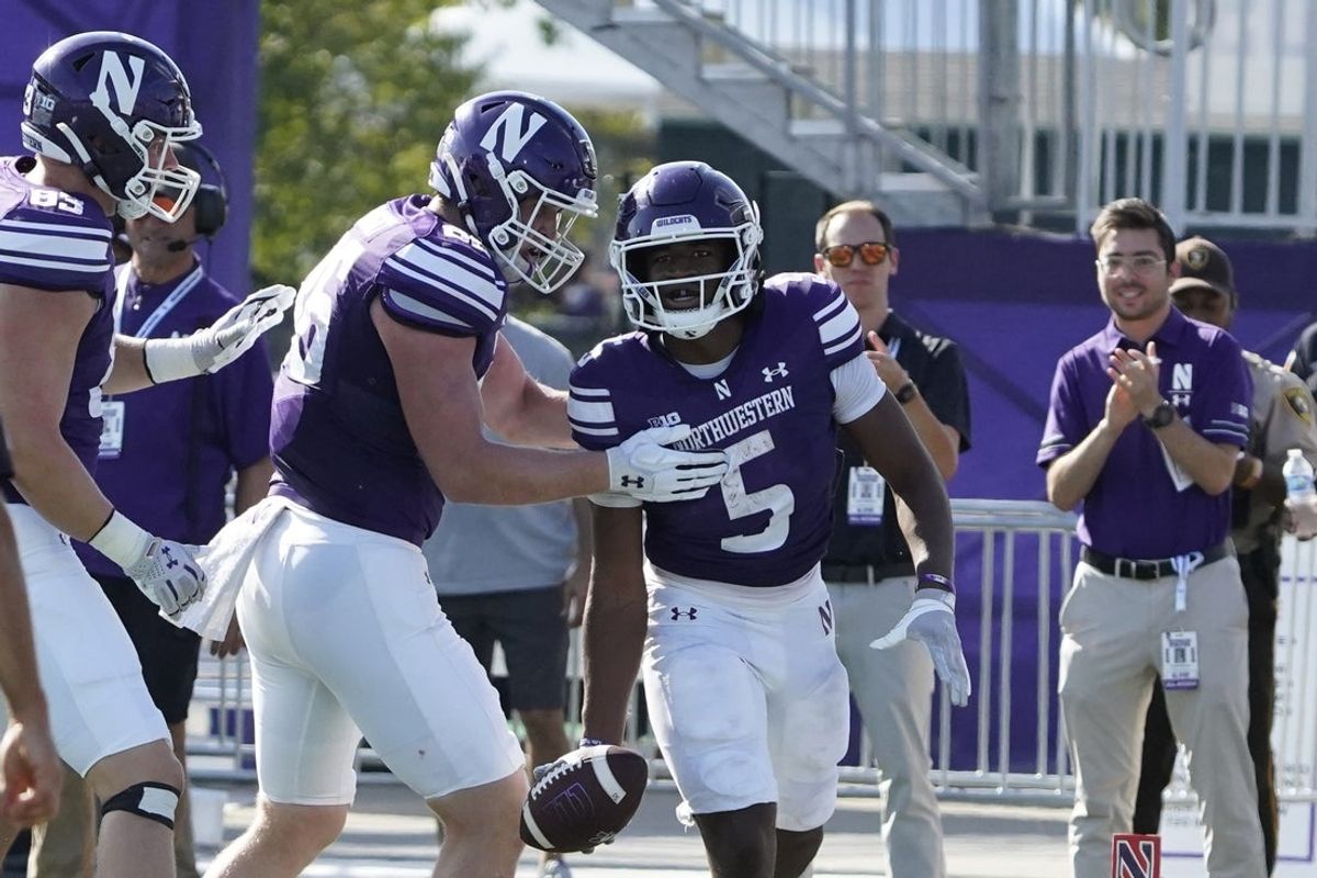 Sep 27, 2025; Evanston, Illinois, USA; Northwestern Wildcats running back Caleb Komolafe (5) celebrates his touchdown against the UCLA Bruins during the first half at Northwestern Medicine Field at Martin Stadium. Mandatory Credit: David Banks-Imagn Images
