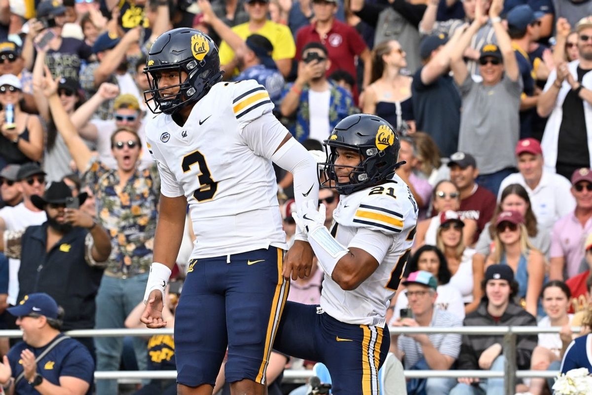 Sep 27, 2025; Chestnut Hill, Massachusetts, USA; California Golden Bears wide receiver Jacob De Jesus (21) celebrates his touchdown with quarterback Jaron-Keawe Sagapolutele (3) during the first half against the Boston College Eagles at Alumni Stadium. Mandatory Credit: Eric Canha-Imagn Images