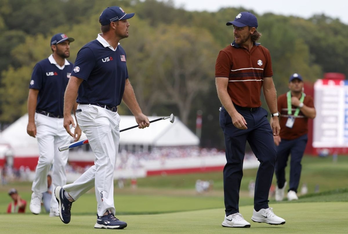 Sep 27, 2025; Bethpage, New York, USA; Team USA golfer Bryson DeChambeau and Team Europe golfer Tommy Fleetwood have a discussion on the 15th hole on the penultimate day of competition for the Ryder Cup at Bethpage Black. Mandatory Credit: Peter Casey-Imagn Images
