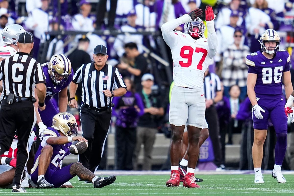 Ohio State Buckeyes defensive end Kenyatta Jackson Jr. (97) celebrates a sack of Washington Huskies quarterback Demond Williams Jr. (2) during the first half of the NCAA football game at Husky Stadium in Seattle on Sept. 27, 2025.