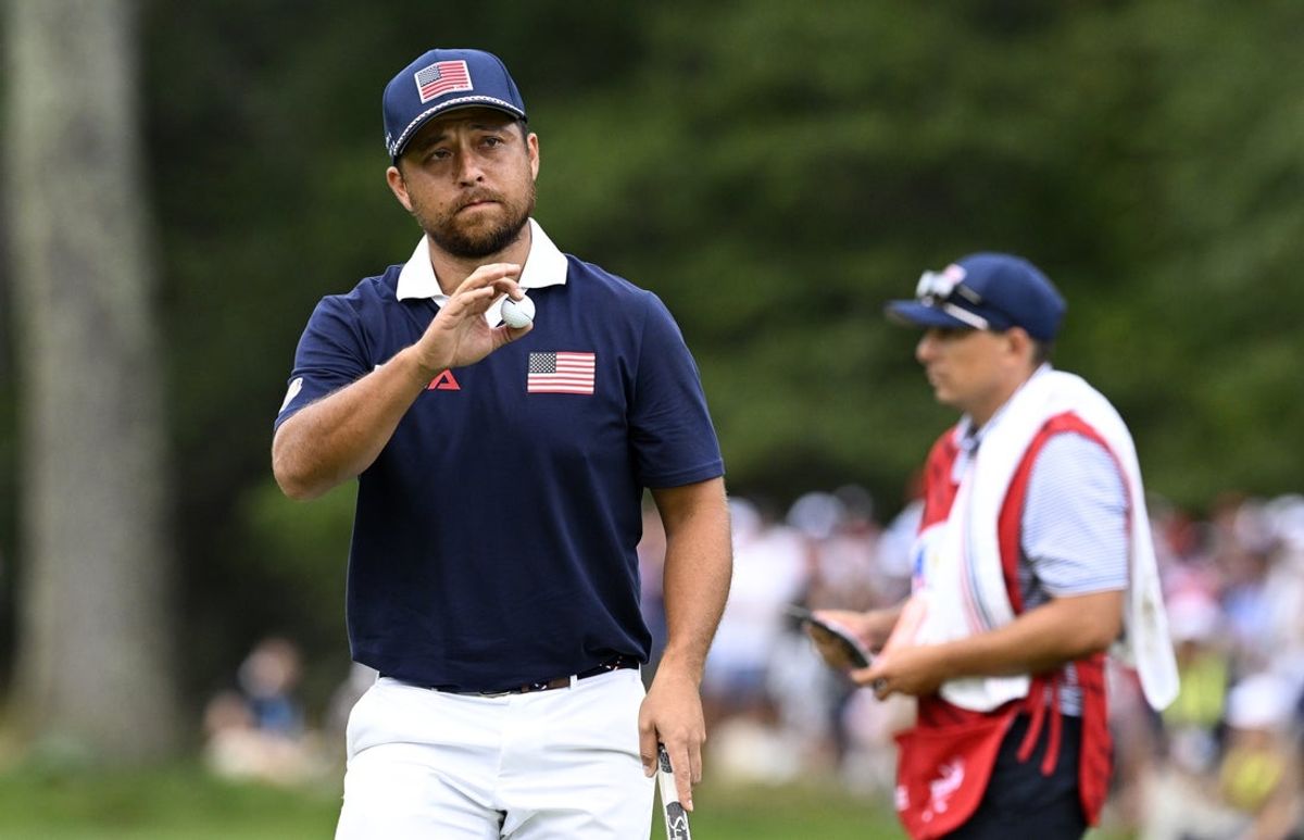 Sep 27, 2025; Bethpage, New York, USA; Team USA golfer Xander Schauffele reacts a putt on the 13th hole on the penultimate day of competition for the Ryder Cup at Bethpage Black. Mandatory Credit: Dennis Schneidler-Imagn Images