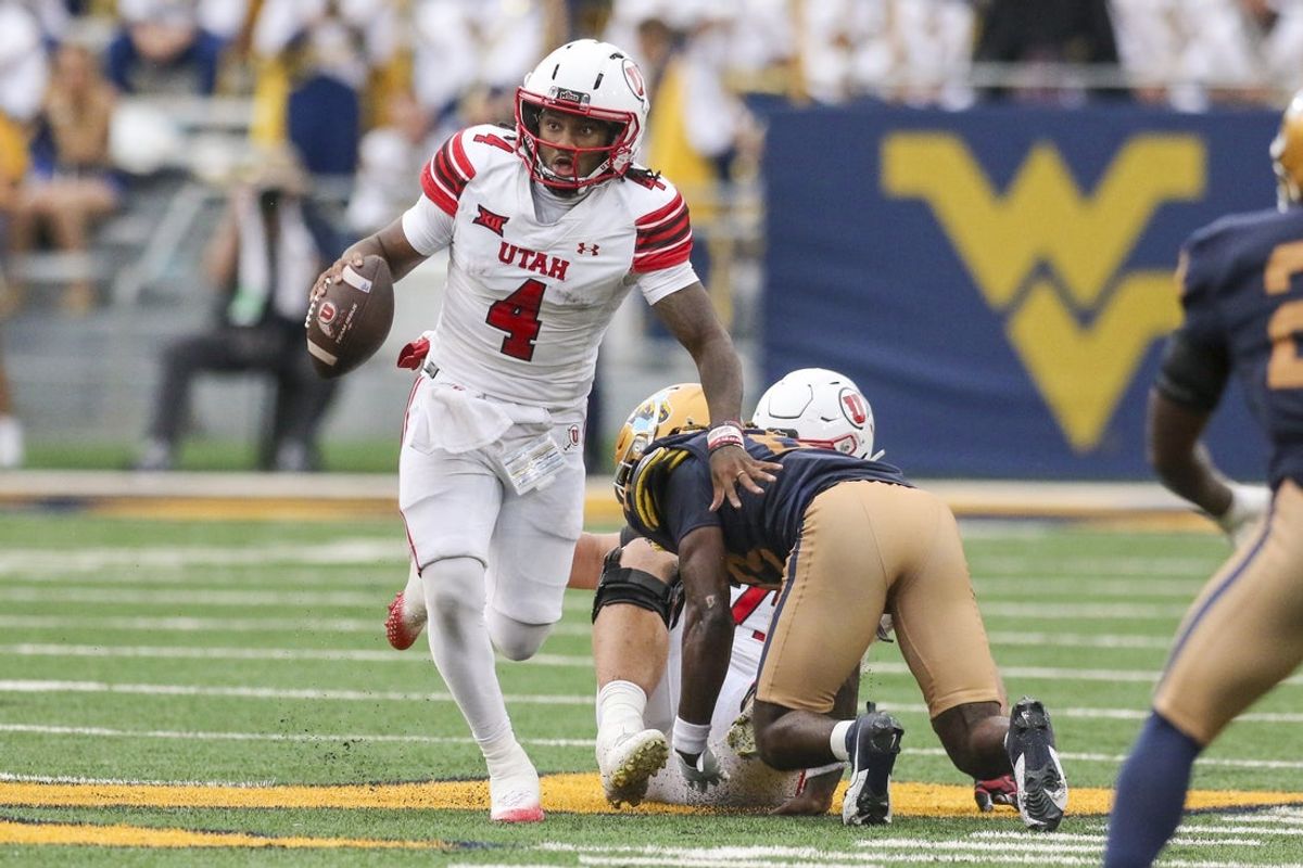 Sep 27, 2025; Morgantown, West Virginia, USA; Utah Utes quarterback Devon Dampier (4) runs out of the pocket during the third quarter against the West Virginia Mountaineers at Milan Puskar Stadium. Mandatory Credit: Ben Queen-Imagn Images