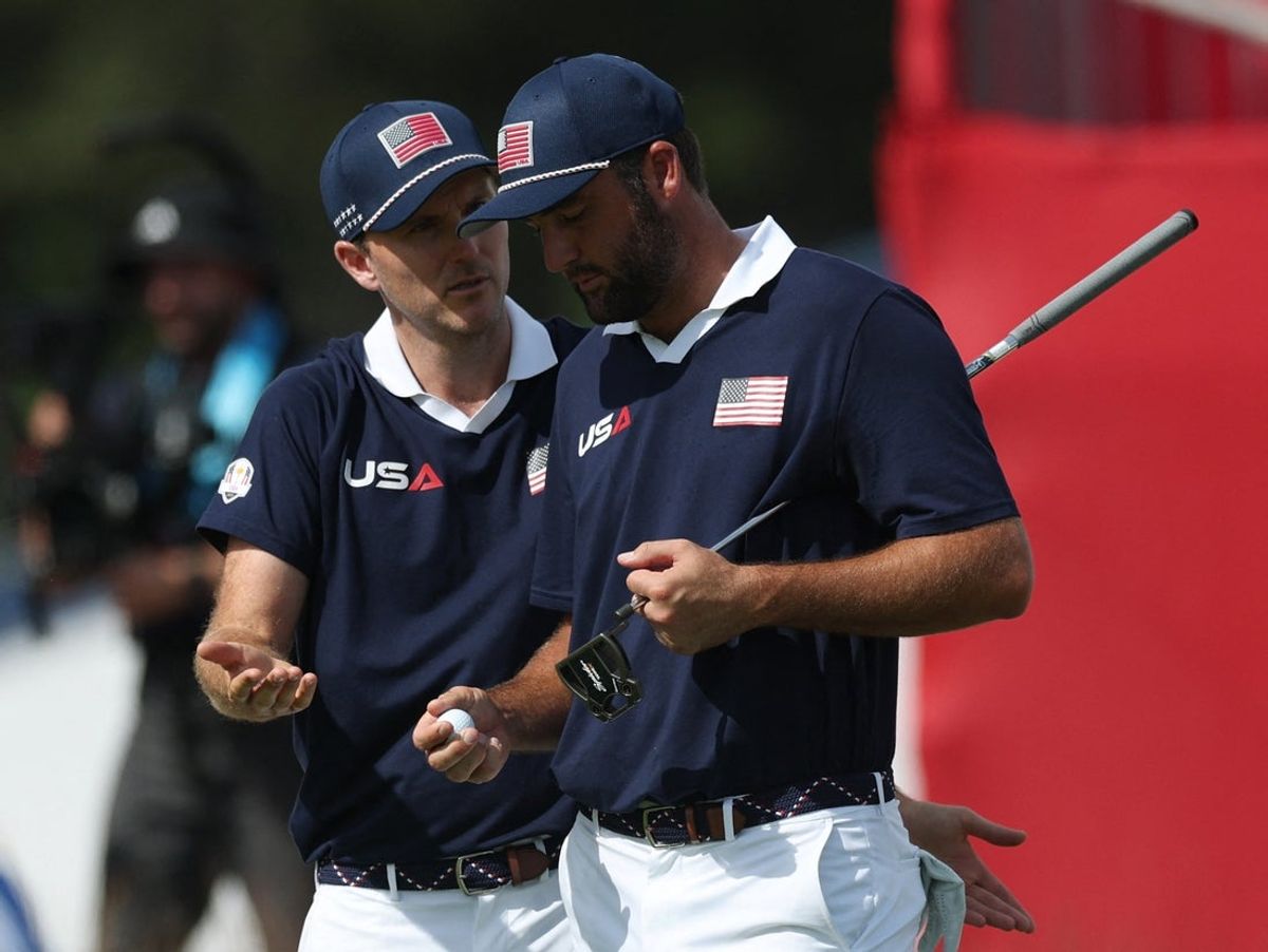 [US, Mexico & Canada customers only] Sep 27, 2025; Bethpage, New York, USA; Team USA's Russell Henley and Team USA's Scottie Scheffler react on the 18th green during the foursomes on the second day of competition for the Ryder Cup at Bethpage Black. Mandatory Credit: Paul Childs-Reuters via Imagn Images