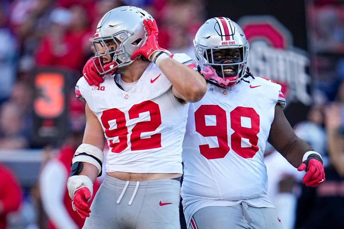 Ohio State Buckeyes defensive lineman Kayden McDonald (98) celebrates a sack with defensive end Caden Curry (92) during the second half of the NCAA football game against the Washington Huskies at Husky Stadium in Seattle on Sept. 27, 2025. Ohio State won 24-6.