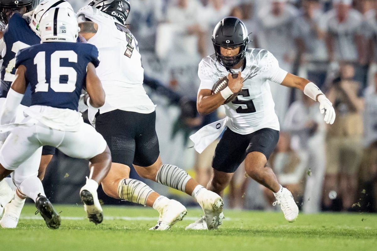 Oregon quarterback Dante Moore carries the ball as the Oregon Ducks face the Penn State Nittany Lions on Sept. 27, 2025, at Beaver Stadium in University Park, Pennsylvania.