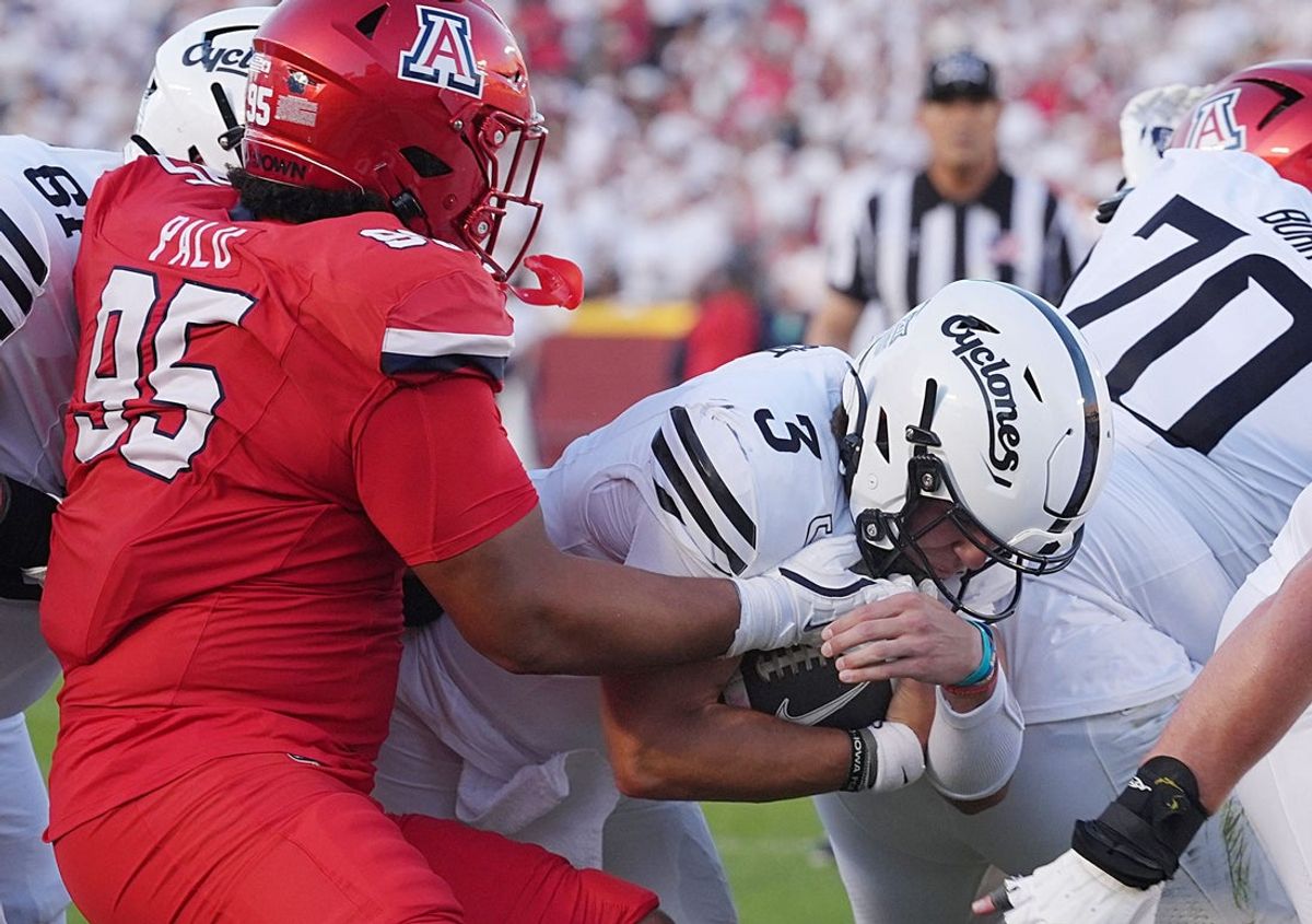 Iowa State Cyclones' quarterback Rocco Becht (3) dives for a touchdown as Arizona Wildcats defensive line Leroy Palu (95) defends during the first quarter in the Big-12 conference showdown on Sept. 27, 2025, at Jack Trice Stadium in Ames, Iowa.