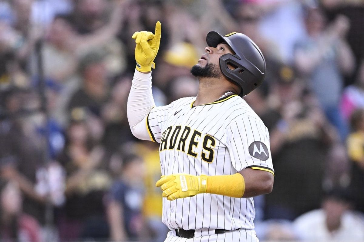 Sep 27, 2025; San Diego, California, USA; San Diego Padres catcher Elias Diaz (17) points skyward after hitting a solo home run during the second inning against the Arizona Diamondbacks at Petco Park. Mandatory Credit: Denis Poroy-Imagn Images