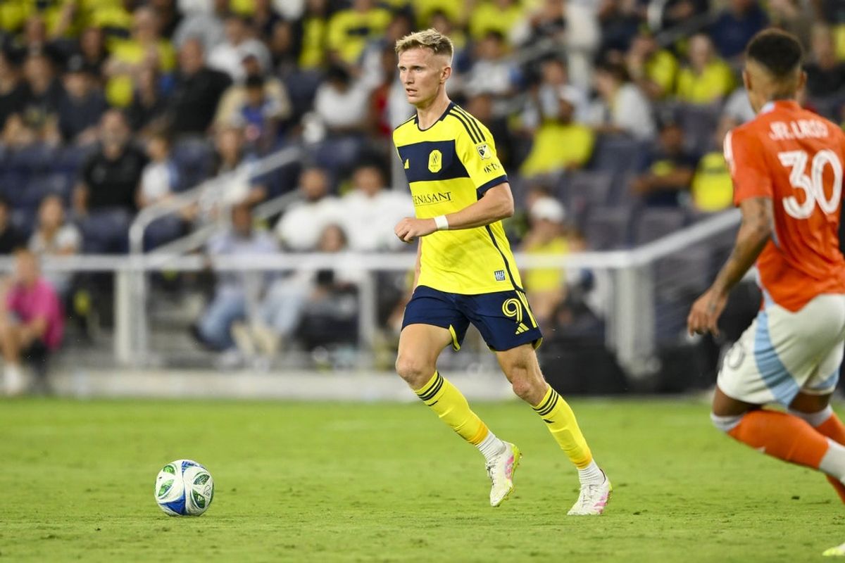 Sep 27, 2025; Nashville, Tennessee, USA;  Nashville SC forward Sam Surridge (9) dribbles the ball against the Houston Dynamo during the first half at Geodis Park. Mandatory Credit: Steve Roberts-Imagn Images