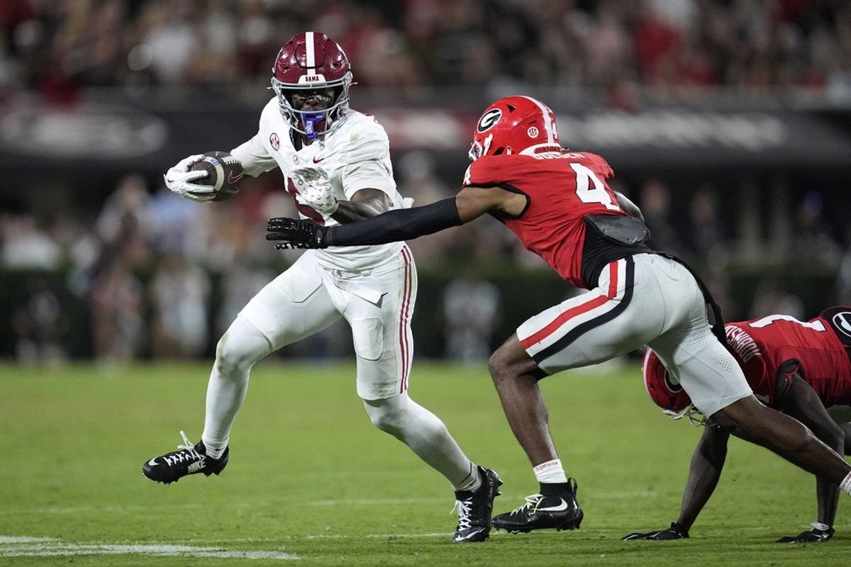 Sep 27, 2025; Athens, Georgia, USA; Alabama Crimson Tide wide receiver Germie Bernard (5) runs against Georgia Bulldogs defensive back Ellis Robinson IV (1) and defensive back KJ Bolden (4) in the second half at Sanford Stadium. Mandatory Credit: Dale Zanine-Imagn Images