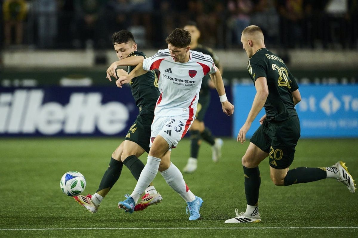 Sep 27, 2025; Portland, Oregon, USA; FC Dallas forward Logan Farrington (23) passes the ball during the first half against Portland Timbers midfielder David Ayala (24) at Providence Park. Mandatory Credit: Troy Wayrynen-Imagn Images