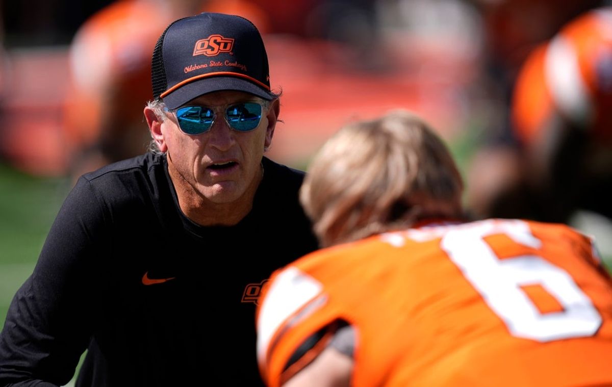 Oklahoma State Interim Head Coach/Offensive Coordinator Doug Meacham talks with Zane Flores (6) before the college football game between the Oklahoma State Cowboys and the Baylor Bears at Boone Pickens Stadium in Stillwater, Okla., Saturday, Sept. 27, 2025.