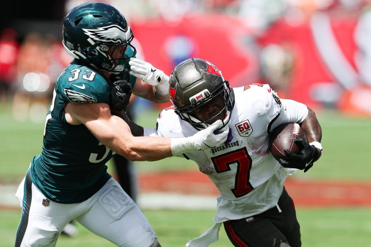 Sep 28, 2025; Tampa, Florida, USA; Tampa Bay Buccaneers running back Bucky Irving (7) attempts to stiff arm Philadelphia Eagles cornerback Cooper Dejean (33) during the first quarter at Raymond James Stadium. Mandatory Credit: Nathan Ray Seebeck-Imagn Images
