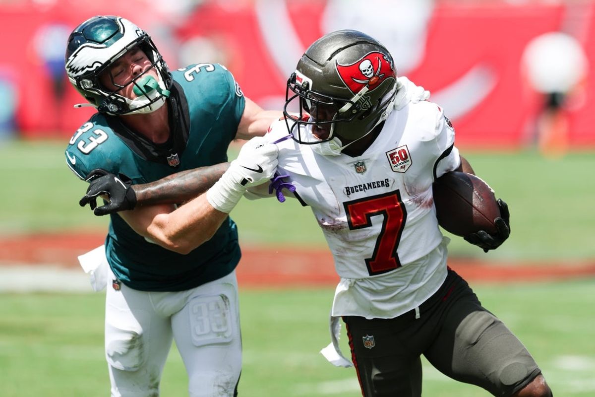 Sep 28, 2025; Tampa, Florida, USA; Tampa Bay Buccaneers running back Bucky Irving (7) attempts to stiff arm Philadelphia Eagles cornerback Cooper Dejean (33) during the first quarter at Raymond James Stadium. Mandatory Credit: Nathan Ray Seebeck-Imagn Images