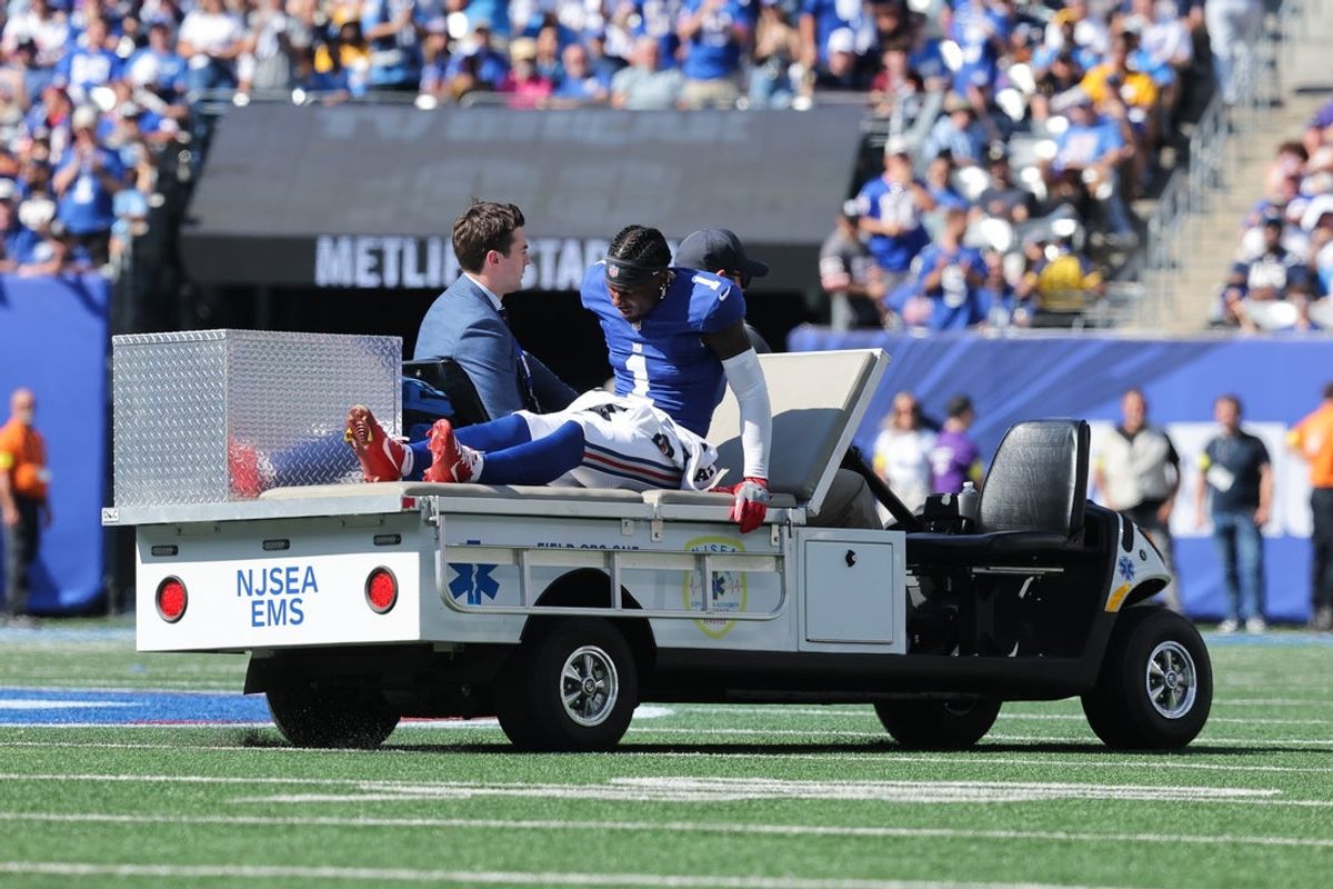 Sep 28, 2025; East Rutherford, New Jersey, USA;  New York Giants wide receiver Malik Nabers (1) is carted off the field following an injury during the second quarter against the Los Angeles Chargers at MetLife Stadium. Mandatory Credit: Brad Penner-Imagn Images