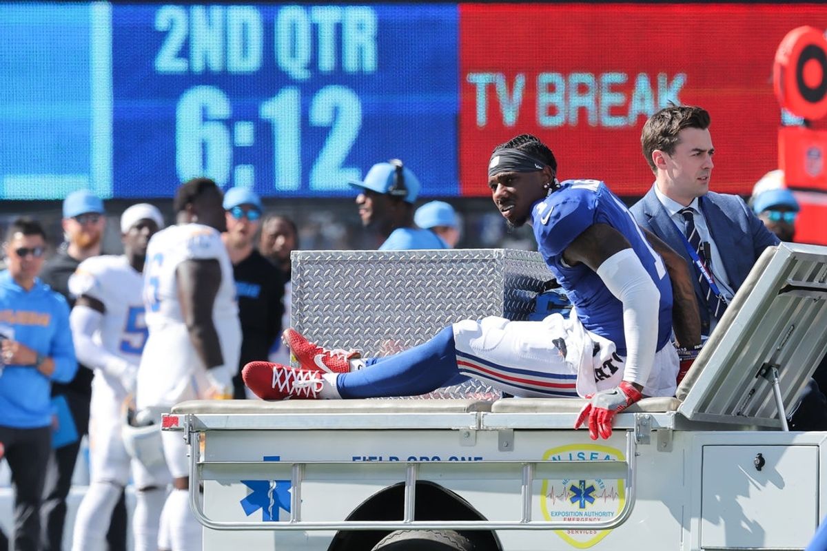 Sep 28, 2025; East Rutherford, New Jersey, USA; New York Giants wide receiver Malik Nabers (1) is carted off the field following an injury during the second quarter against the Los Angeles Chargers at MetLife Stadium. Mandatory Credit: Brad Penner-Imagn Images