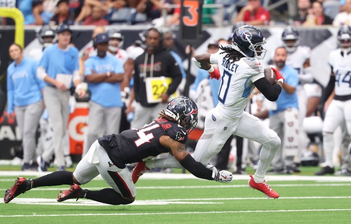 Sep 28, 2025; Houston, Texas, USA; Tennessee Titans wide receiver Calvin Ridley runs against Houston Texans cornerback Derek Stingley Jr. (24) during the first half at NRG Stadium. Mandatory Credit: Troy Taormina-Imagn Images